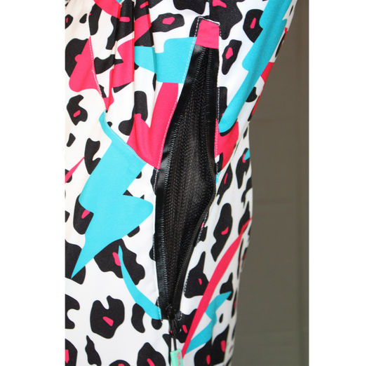 Close-up of an open black mesh pit vent on a white, teal, pink, and black Miami Ice Shred Suit