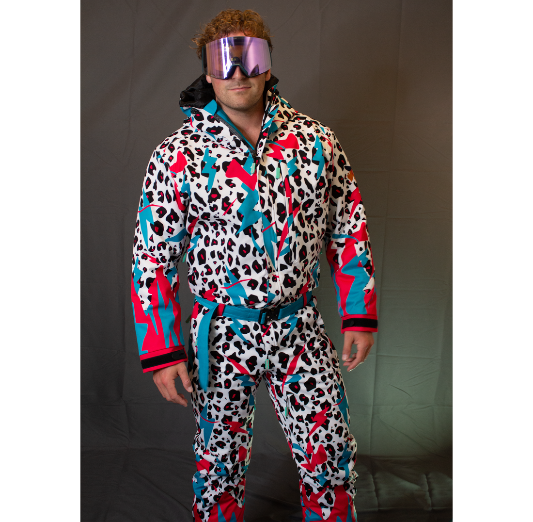 Model wearing the white Miami Ice Shred Suit with teal and red graphics, goggles, hood, belt, cuffs, and front pockets visible